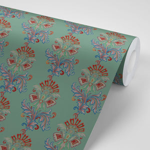 Fleur wallpaper by Tatie Lou in sage green, partly unrolled roll showing stylised flower sprays