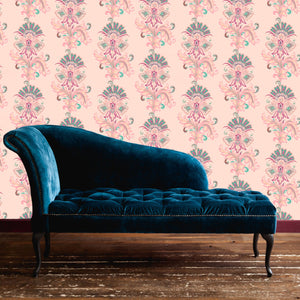 Fleur wallpaper by Tatie Lou in pink, stylised flower sprays behind a sofa in a living room