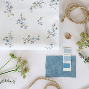 Forget Me Not fabric by Seed Home Designs in blue and green, full repeat of scattered forget-me-nots