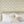 Forget Me Not wallpaper by Seed Home Designs in cream, scattered forget-me-nots in a bedroom