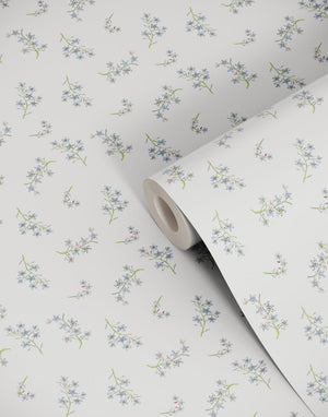 Forget Me Not wallpaper by Seed Home Designs in blue and green, roll showing scattered forget-me-nots