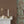 Brown Stone grasscloth grasscloth by Deus ex Gardenia in brown, a woven grasscloth texture above a sideboard