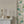 Complex White grasscloth grasscloth by Deus ex Gardenia in white, a woven grasscloth texture above a sideboard