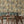 Gentlemen Birds wallpaper by Brand McKenzie in rust, birds hidden among leaves in a dining area