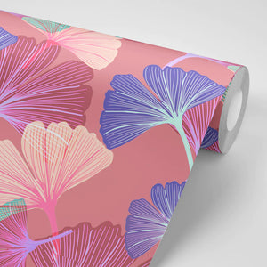 Ginkgo wallpaper by Tatie Lou in pink, partly unrolled roll showing oversized ginkgo leaves