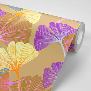 Ginkgo wallpaper by Tatie Lou in orange, partly unrolled roll showing oversized ginkgo leaves
