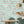 The Grand Pour wallpaper by Brand McKenzie in aqua, swimmers among cocktail glasses in a dining room