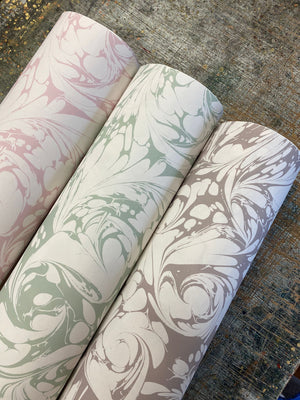 Flourish wallpaper by House of Amitié in green, roll showing flowing scrolls