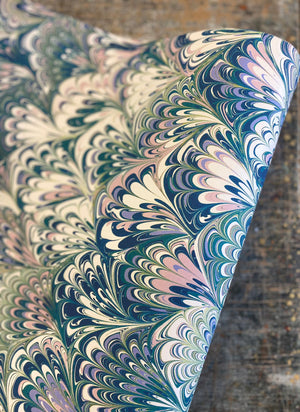 Serpentine in Spring wallpaper by House of Amitié in blue and green, roll showing peacock-feather marbling