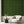 Halo Boulevard wallpaper by Liberty James Studio in green, a geometric halo pattern in a living room
