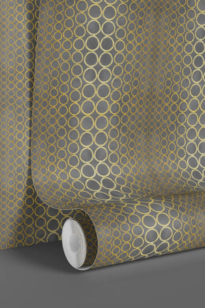 Halo Boulevard wallpaper by Liberty James Studio in gold, partly unrolled roll showing a geometric halo pattern