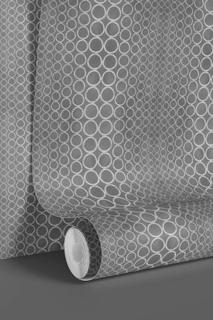 Halo Boulevard wallpaper by Liberty James Studio in silver, sample roll showing a geometric halo pattern