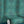 Halo Boulevard wallpaper by Liberty James Studio in teal, partly unrolled roll showing a geometric halo pattern
