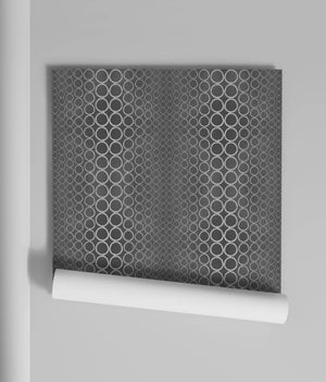 Halo Boulevard wallpaper by Liberty James Studio in silver, partly unrolled roll showing a geometric halo pattern