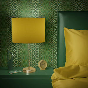 Halo Boulevard wallpaper by Liberty James Studio in green, a geometric halo pattern behind a sofa in a living room