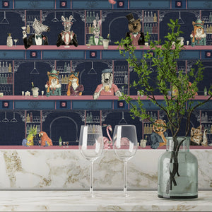 Happy Hour wallpaper by Brand McKenzie in navy and pink, animals at a cocktail bar above kitchen cabinets