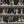 Happy Hour wallpaper by Brand McKenzie in black, pattern detail of animals at a cocktail bar