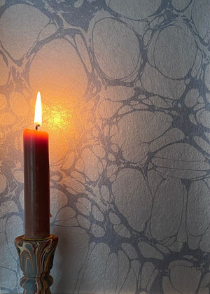 Moucheté wallpaper by House of Amitié in blue, soft marbled spots on a feature wall