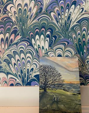 Serpentine in Spring wallpaper by House of Amitié in blue and green, peacock-feather marbling in a styled room setting