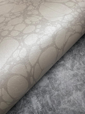 Moucheté wallpaper by House of Amitié in pink, sample roll showing soft marbled spots