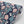 Honiton Lace wallpaper by Annika Reed in navy and pink, roll showing lace-style flowers