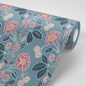 Honiton Lace wallpaper by Annika Reed in blue and pink, partly unrolled roll showing lace-style flowers