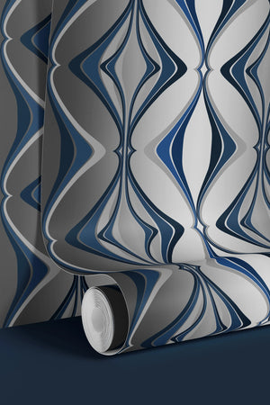 Hourglass wallpaper by Liberty James Studio in blue and silver, partly unrolled roll showing a retro hourglass wave