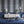 Hourglass wallpaper by Liberty James Studio in blue and silver, a retro hourglass wave in a living room