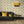 Hourglass wallpaper by Liberty James Studio in yellow and black, a retro hourglass wave in a living room