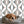 Hourglass wallpaper by Liberty James Studio in grey, a retro hourglass wave behind a dining table