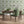 Hourglass wallpaper by Liberty James Studio in green, a retro hourglass wave behind a bed