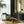 Hourglass wallpaper by Liberty James Studio in green and gold, a retro hourglass wave in a living room