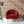 Hourglass wallpaper by Liberty James Studio in red and navy, a retro hourglass wave in a bedroom