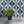 Hourglass wallpaper by Liberty James Studio in blue, a retro hourglass wave behind a sofa in a living room