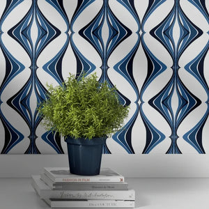 Hourglass wallpaper by Liberty James Studio in blue, a retro hourglass wave behind a sofa in a living room