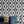 Hourglass wallpaper by Liberty James Studio in teal and gold, roll showing a retro hourglass wave