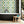 Hourglass wallpaper by Liberty James Studio in turquoise and yellow, sample roll showing a retro hourglass wave