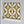 Hourglass wallpaper by Liberty James Studio in yellow and black, roll showing a retro hourglass wave