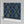 Hourglass wallpaper by Liberty James Studio in navy and gold, a retro hourglass wave in a living room