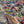 Dusk Tourmaline wallpaper by House of Amitié in purple and green, flat sample of hand-marbled swirls