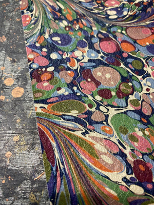 Dusk Tourmaline wallpaper by House of Amitié in purple and green, flat sample of hand-marbled swirls