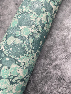 Ditzy wallpaper by House of Amitié in green, roll showing fine hand-marbled pattern