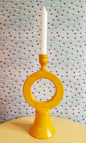 Malo wallpaper by Claire de Quénetain in red, scattered tiny motifs behind a console table