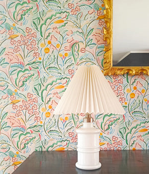 Paloma wallpaper by Claire de Quénetain in pink and green, a hand-painted floral design above a sideboard