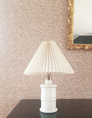 Margaux wallpaper by Claire de Quénetain in green, delicate sprigs behind a console table