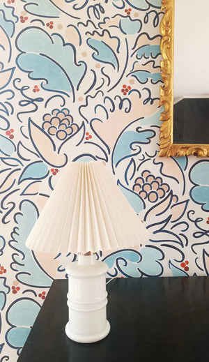 Leopolde wallpaper by Claire de Quénetain in pink and blue, a hand-painted floral design above a sideboard