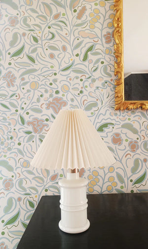 Barbara wallpaper by Claire de Quénetain in pink, a hand-painted floral design above a sideboard