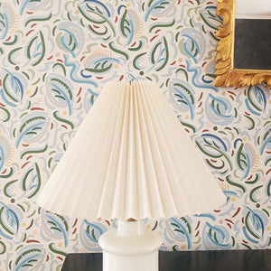 Igor wallpaper by Claire de Quénetain in blue, leafy sprigs above a sideboard
