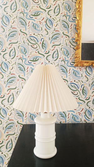 Igor wallpaper by Claire de Quénetain in blue, leafy sprigs above a sideboard