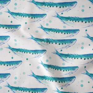 Swimming Sardines fabric by Seed Home Designs in blue and white, draped, showing swimming sardines